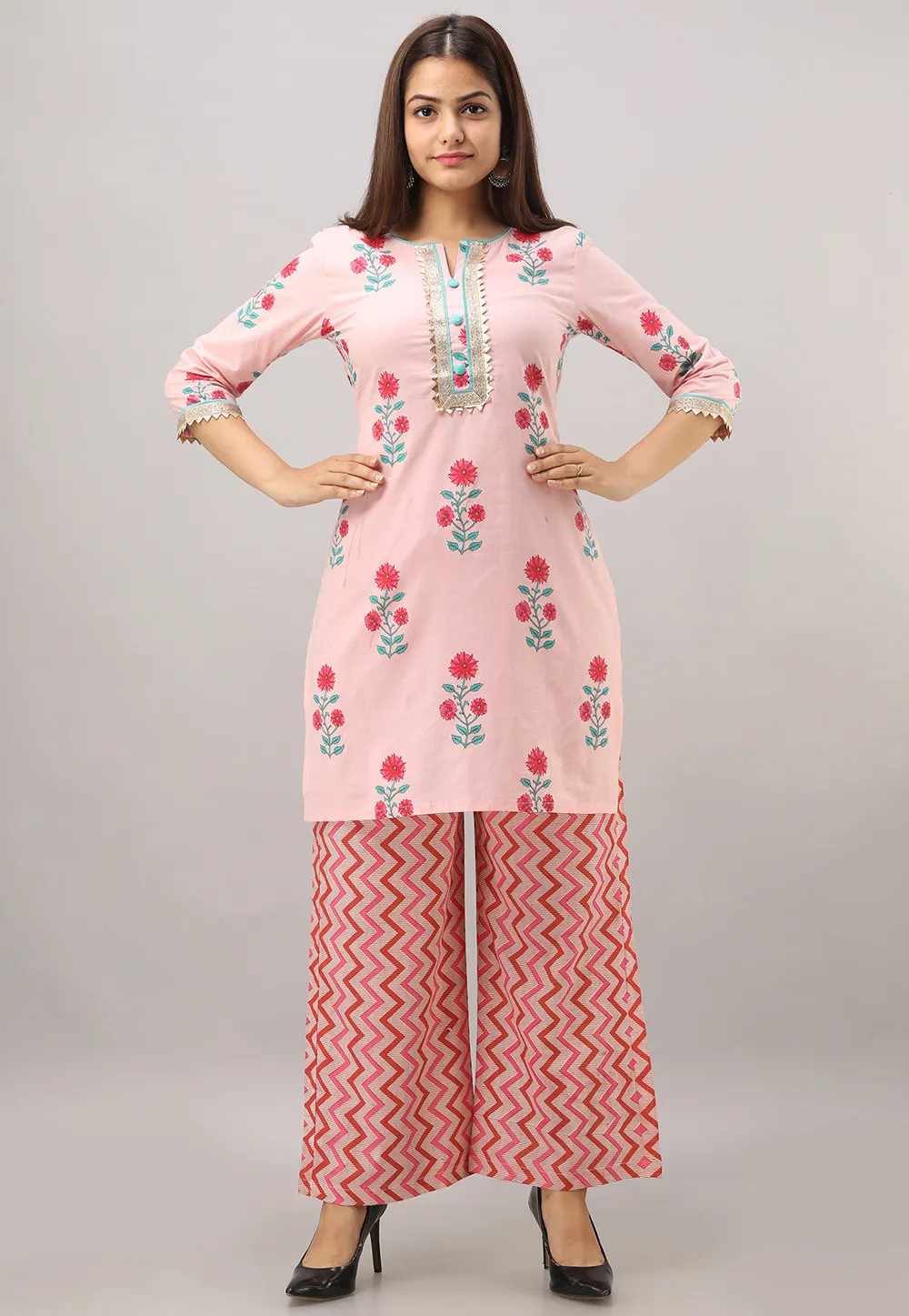 a woman in a pink short kameez with plazo dress